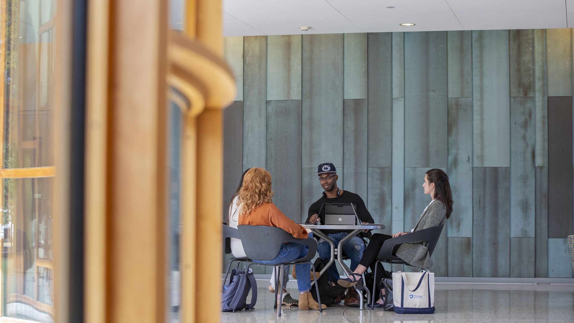 three students seated at a table