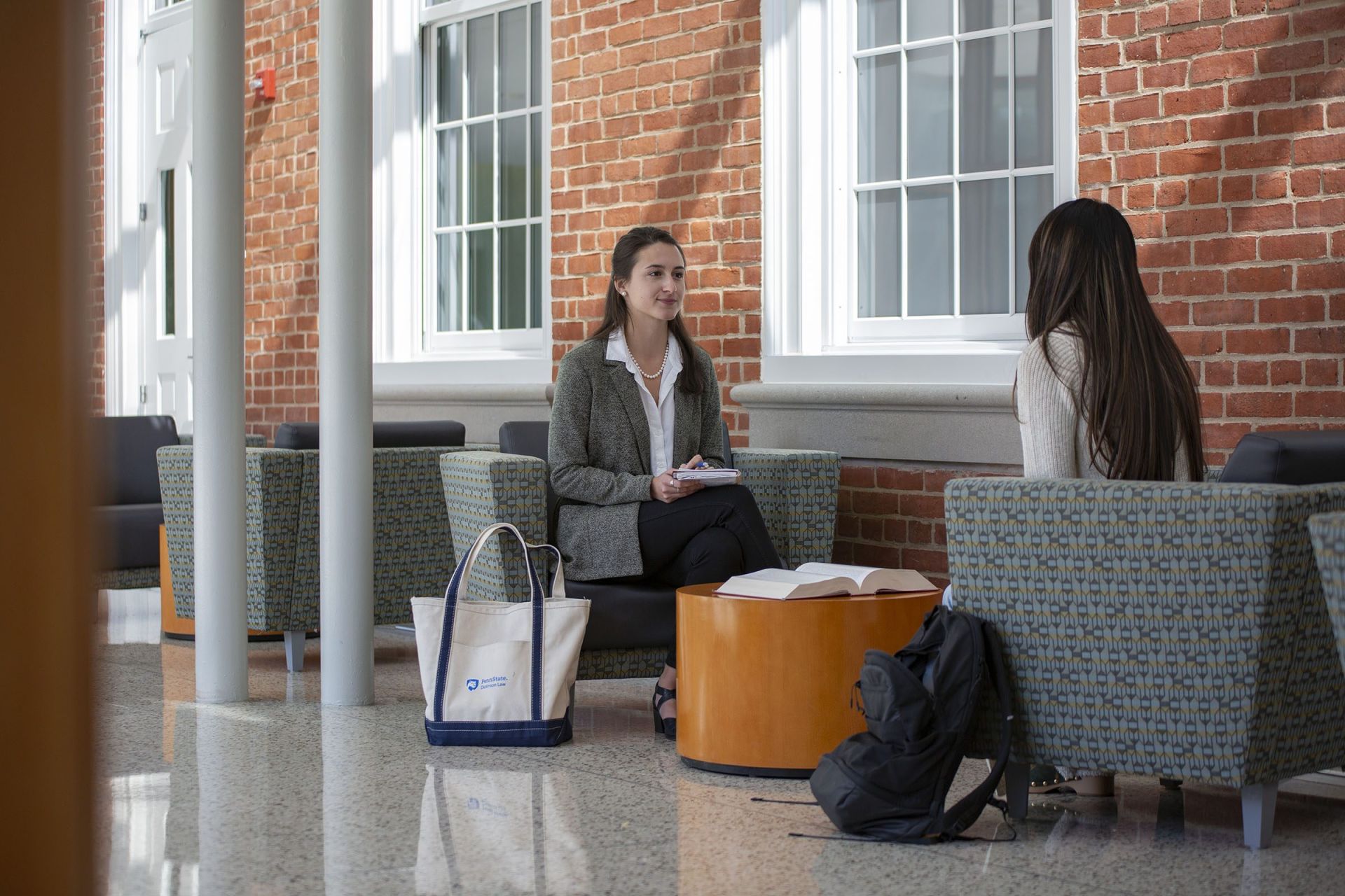 Law students seated across from one another in a common area.